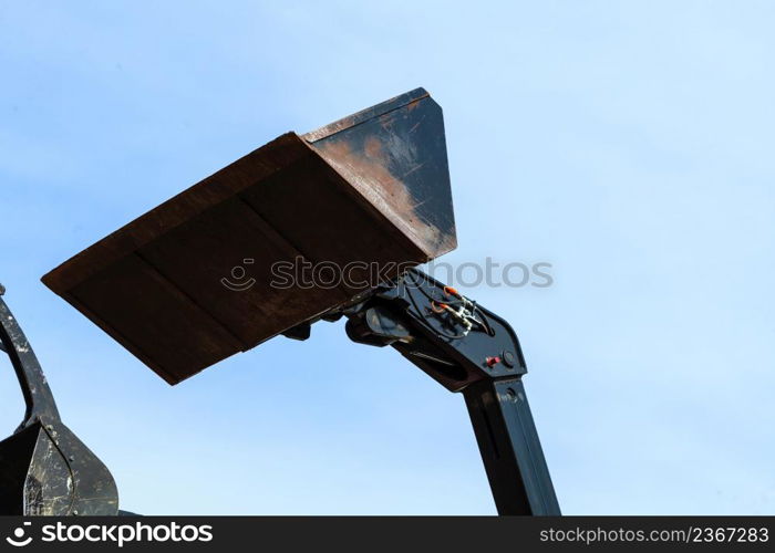 Machines, architecture building, heavy equipment concept. Bucket loader with blue sky in background. Bucket loader with blue sky in background