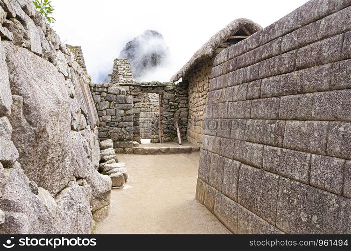 Machu Picchu ruins with foggy sky in the back