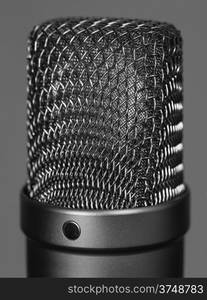 Macro abstract photo of a large diaphragm studio microphone. Shallow depth of field.