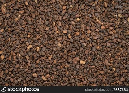 Macro background and texture of chicory granules often used with or as a substitute for coffee, made from the root of the chicory plant, Cichorium intybus, also known as endive.