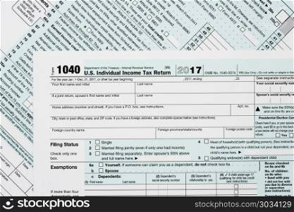 Macro close up of 2017 IRS form 1040. Close macro photo of USA IRS tax form 1040 for year 2017 taken from above. Macro close up of 2017 IRS form 1040