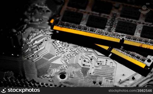 Macro Close up of computer RAM chip and motherboard on dark background