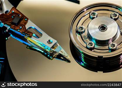 Macro Close up of inside of magnetic Hard Disc Drive with mirror surface and read writer head