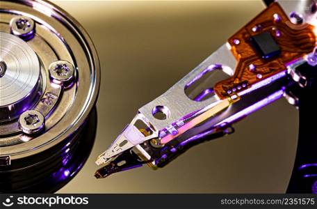 Macro Close up of inside of magnetic Hard Disc Drive with mirror surface and read writer head