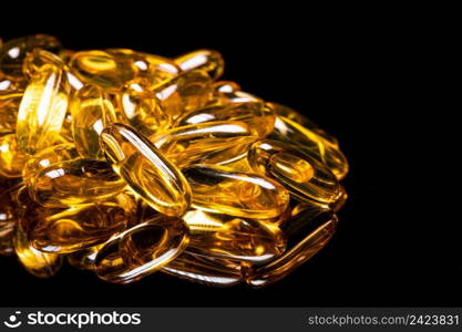 Macro Close up of Omega 3 gel capsule on a reflective black background