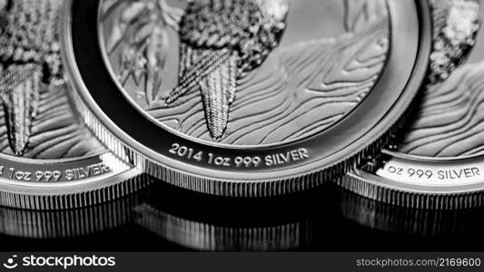 Macro Close up of Silver Bullion Coin on a black mirror background