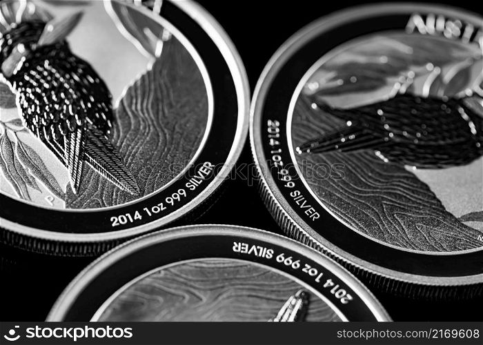 Macro Close up of Silver Bullion Coin on a black mirror background