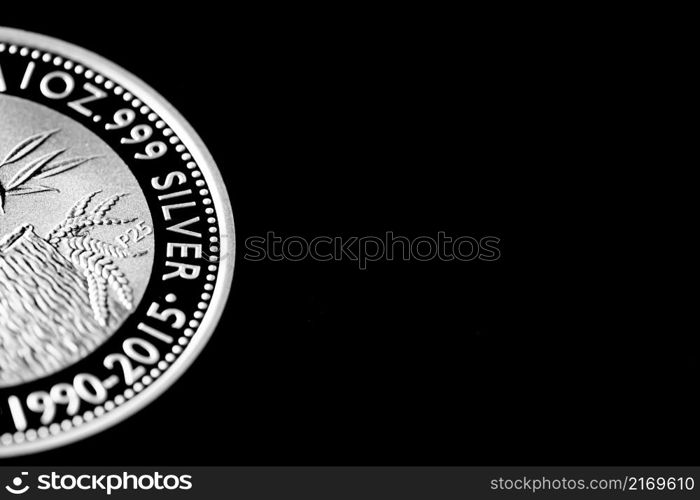 Macro Close up of Silver Bullion Coin on a black mirror background