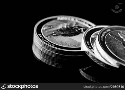 Macro Close up of Silver Bullion Coin on a black mirror background