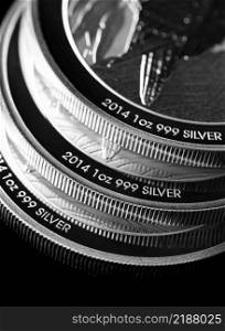 Macro Close up of  Silver Bullion Coin on a black mirror background