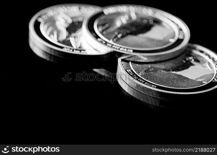 Macro Close up of  Silver Bullion Coin on a black mirror background