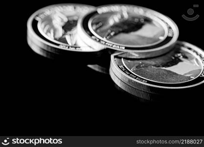 Macro Close up of  Silver Bullion Coin on a black mirror background