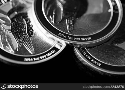 Macro Close up of Silver Bullion Coin on a black mirror background