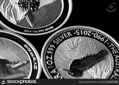 Macro Close up of Silver Bullion Coin on a black mirror background