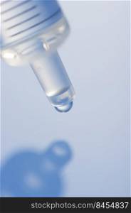Macro image of a syringe with droplet. Syringe macro view in blue.
