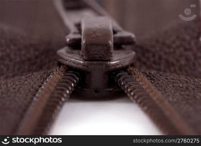 macro image of brown zipper being unzipped