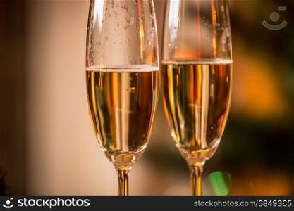 Macro image of champagne bubbles in two glasses