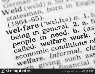 Macro image of dictionary definition of word welfare
