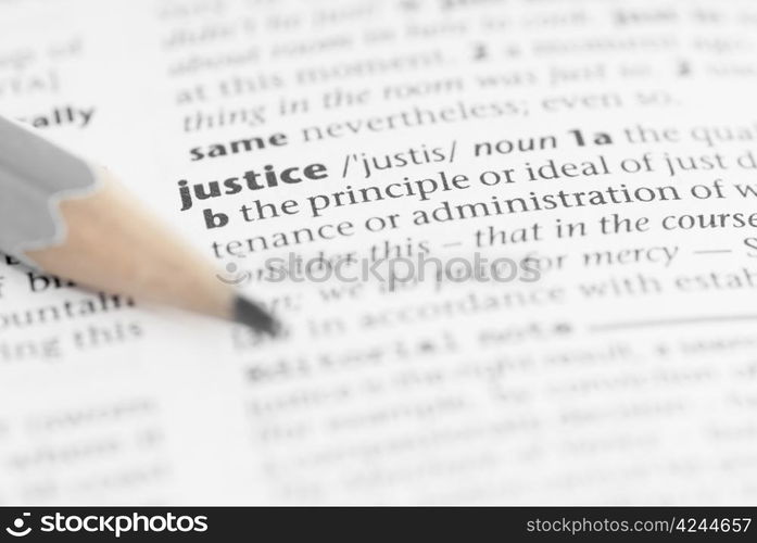 Macro image of dictionary word: Justice, and pencil.