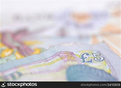 Macro image of English bank notes. Focus on ?5 note.