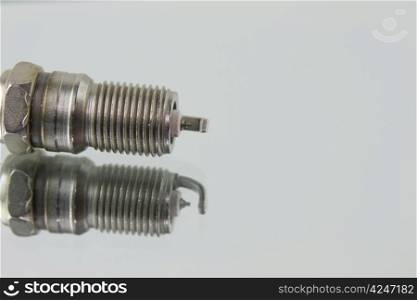 macro of a new automotive spark plug with reflection