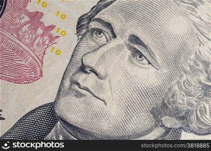 Macro of Alexander Hamilton portrait on ten dollar bill.