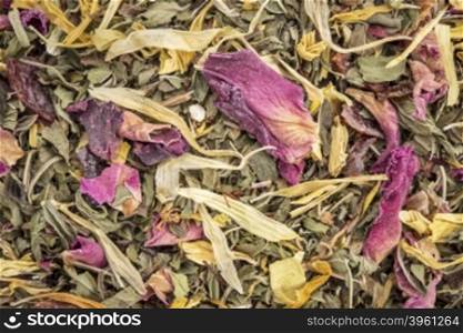 Macro of healthy stomach herbal tea - a blend of peppermint, spearmint, ginger, hisbiscus, rosehip, red rose,, almond, and osmanthus.
