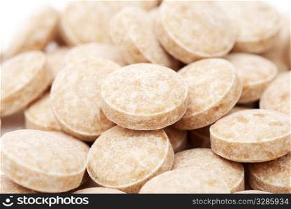 macro of heap of pills isolated on the white background