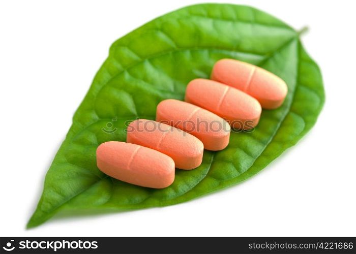 macro of prescription pills over green leaf isolated