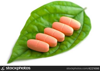 macro of prescription pills over green leaf isolated