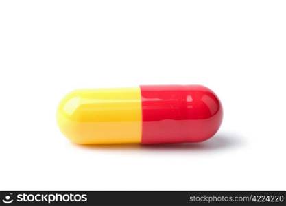 macro of red and yellow capsule pill isolated
