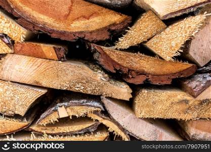 Macro photo of chopped pine wood stacked in pile