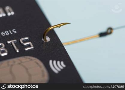 Macro photo of credit card on fishing hook fraud data leak money stealing phishing concept