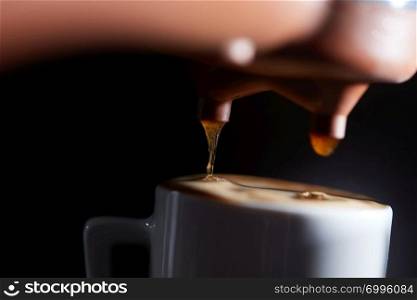 Macro photo of making fresh espresso coffee in a coffee machine. Breakfast. Making fragrant morning coffee in the coffee machine. Macro photo