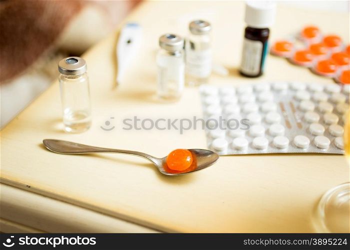 Macro photo of pills in blisters and ampules on bedside table