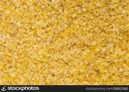 Macro photograph of raw, light-coloured, fine-ground burghul or bulgur wheat, a staple of the Middle Eastern diet and considered a health food in the West as it has a lower glycemic index than white rice and more fibre and minerals.