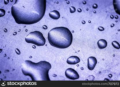 Macro picture of water drops on a metal surface