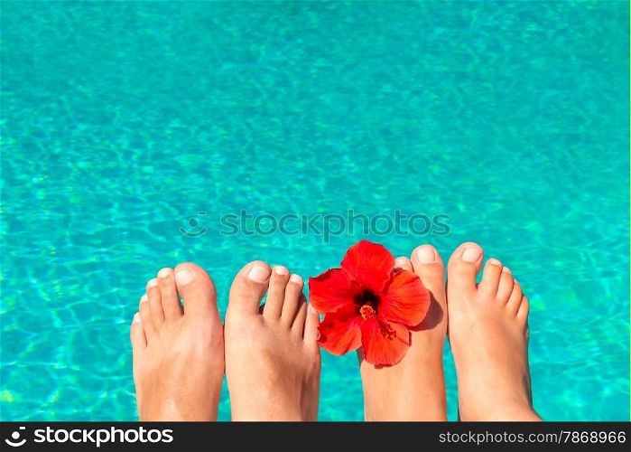 macro picture the newlyweds feet by the pool with flower