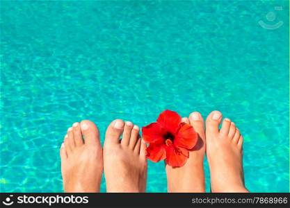 macro picture the newlyweds feet by the pool with flower