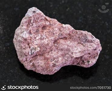 macro shooting of natural mineral rock specimen - Ash Tuff stone on dark granite background
