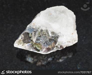 macro shooting of natural mineral rock specimen - rock crystal of quartz gemstone on dark granite background