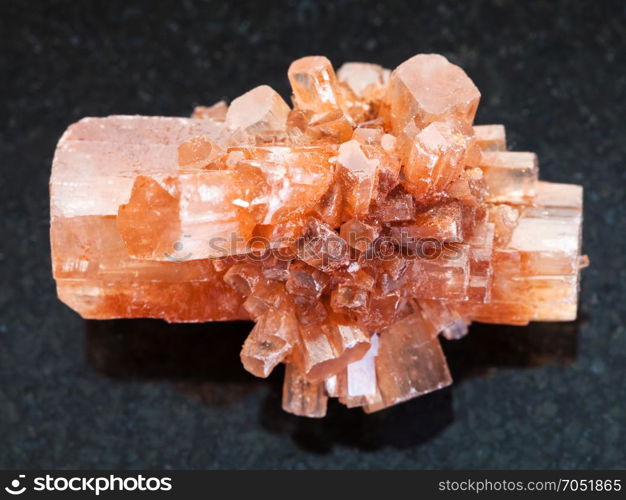 macro shooting of natural mineral rock specimen - rough crystal of Aragonite gemstone on dark granite background from Tazouta, Morocco