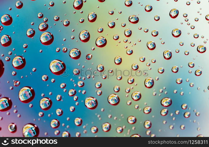 Macro shot detail reflection of 20 Euro banknote in water drops. Colorful water drops background