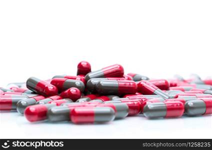 Macro shot detail selective focus of red and grey capsule pills isolated on white background with copy space for text. Migraine prophylaxis medicine