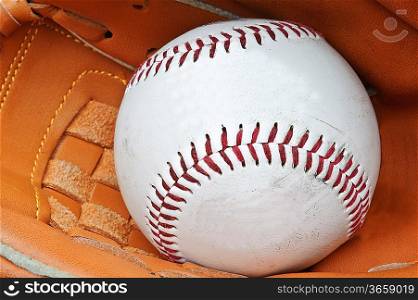 Macro shot of baseball in glove with shallow depth of field for attention on ball
