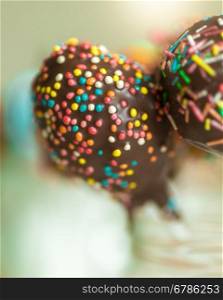 Macro shot of colorful sprinkles on chocolate cake pops