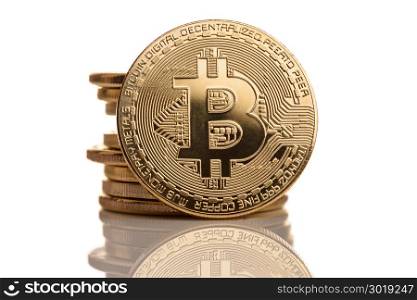 Macro shot of crypto currency gold Bitcoin coins. Isolated on white background