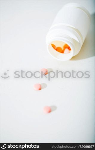 Macro shot of tablets and plastic bottle