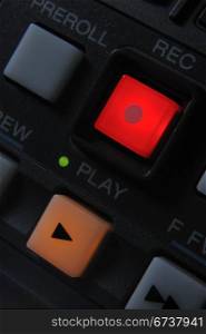 "Macro shot of the orange color "Play" and red "Record" buttons. Also visible Preroll button."