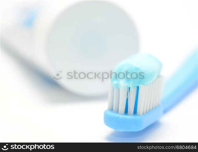 Macro shot of toothbrush and toothpaste on the white background.